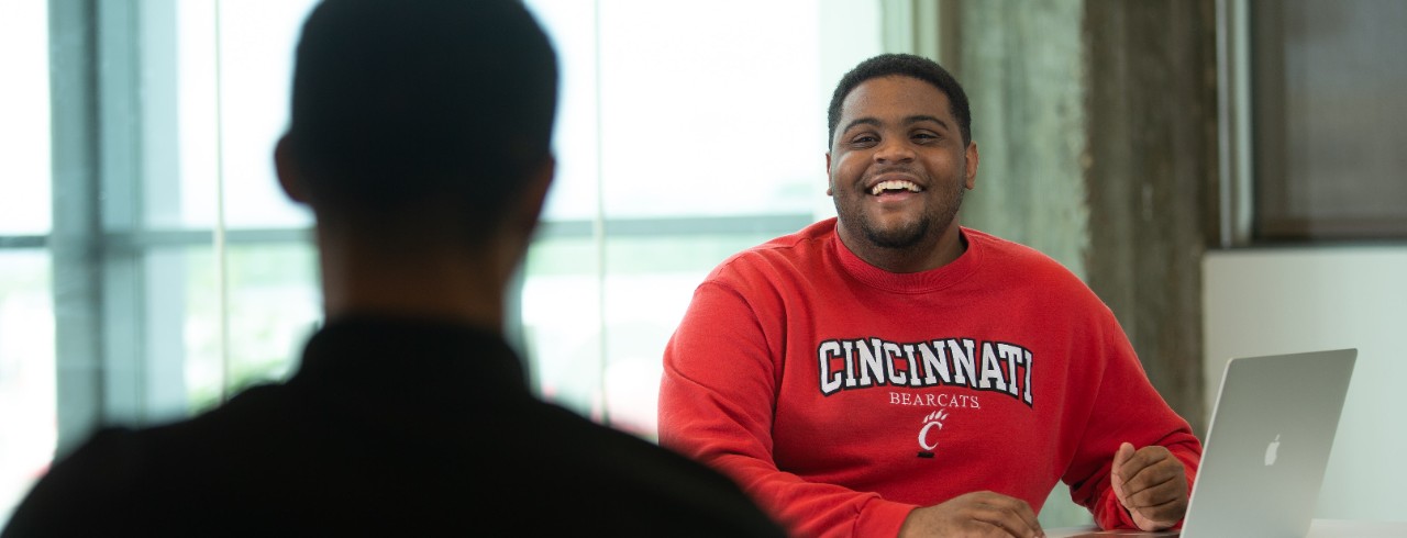 Two students sitting next to. each other in a classroom