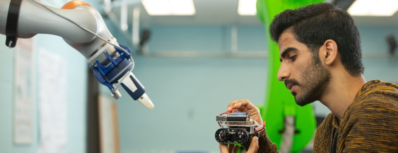 Student using a robotics device