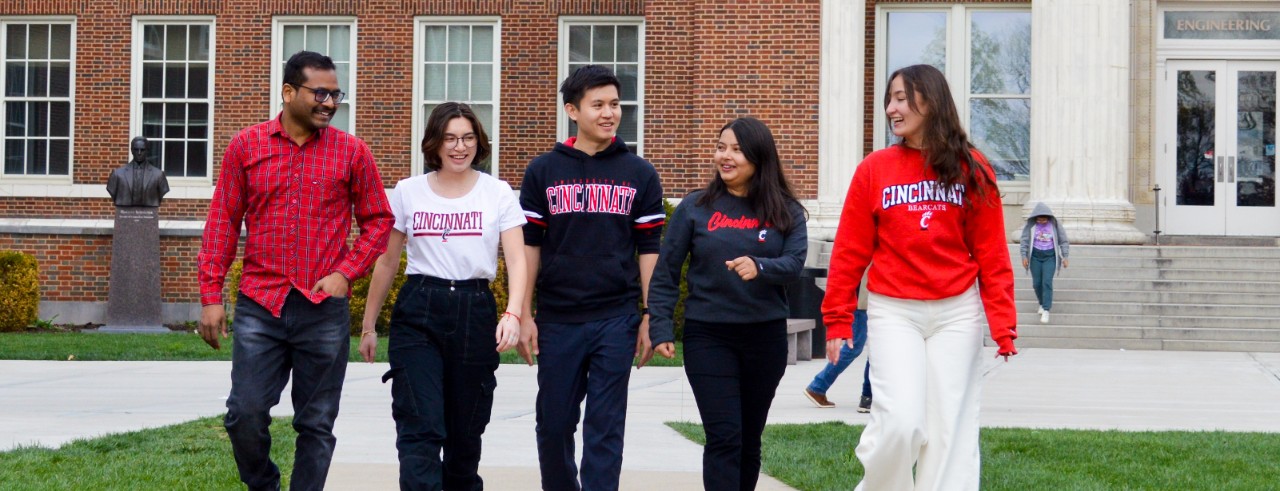 five college students walk outdoors