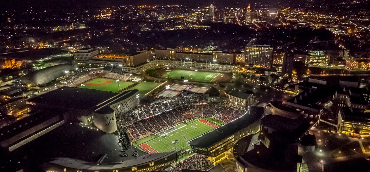 Aerial shot of Nippert Stadium and surrounding city at night