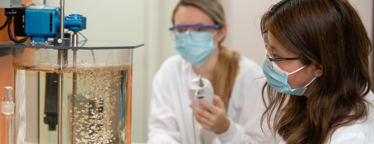 Two students working in environmental engineering lab